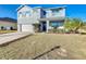 Two-story house with gray siding, blue door, and attached garage at 6163 Forest Ridge Way, Winter Haven, FL 33881