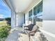 Inviting front porch with a wicker bench and pretty flowers at 6163 Forest Ridge Way, Winter Haven, FL 33881