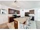 Eat-in kitchen boasts a center island with seating, granite countertops, and ample cabinet space at 6163 Forest Ridge Way, Winter Haven, FL 33881