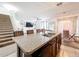 Spacious eat-in kitchen with stairs, featuring a center island, modern lighting, and open layout at 6163 Forest Ridge Way, Winter Haven, FL 33881