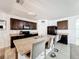 Well-lit kitchen featuring a center island with seating, dark wood cabinets, and stainless-steel appliances at 6163 Forest Ridge Way, Winter Haven, FL 33881