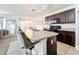 Open-concept eat-in kitchen features a large island with seating, modern appliances, and bright lighting at 6163 Forest Ridge Way, Winter Haven, FL 33881