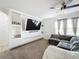 Bright and airy living room with built-in shelving, a large TV, and a comfortable sectional sofa at 6163 Forest Ridge Way, Winter Haven, FL 33881