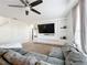Spacious living room featuring a large sectional sofa and flat-screen TV at 6163 Forest Ridge Way, Winter Haven, FL 33881
