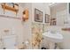Small bathroom with pedestal sink and floral decor at 7403 Glen Oaks Way # 82, Winter Park, FL 32792