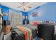 Blue bedroom with ceiling fan and large window at 7403 Glen Oaks Way # 82, Winter Park, FL 32792