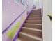 Carpeted stairs with purple and green walls at 7403 Glen Oaks Way # 82, Winter Park, FL 32792