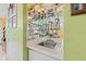 Small wet bar with sink and mirrored backsplash at 7403 Glen Oaks Way # 82, Winter Park, FL 32792