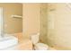 Modern bathroom with a stylish vanity, toilet, and glass-enclosed shower with rainfall shower head at 7535 Brooklyn Dr, Kissimmee, FL 34747
