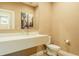 Modern bathroom with a floating vanity, stylish mirror, and neutral color scheme at 7535 Brooklyn Dr, Kissimmee, FL 34747