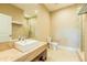 Bathroom featuring a sleek vanity, toilet, and glass-enclosed shower with elegant tile work at 7535 Brooklyn Dr, Kissimmee, FL 34747