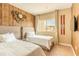 Shared bedroom with two beds, wood accent wall, skis and view of community at 7535 Brooklyn Dr, Kissimmee, FL 34747