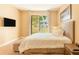 Cozy bedroom with a large bed, plush carpet, and sliding glass door at 7535 Brooklyn Dr, Kissimmee, FL 34747