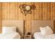 Cozy bedroom with rustic wood accent wall and decorative clock at 7535 Brooklyn Dr, Kissimmee, FL 34747