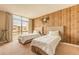 Charming bedroom with wood accent wall, two beds, and plenty of natural light from a large window at 7535 Brooklyn Dr, Kissimmee, FL 34747