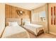 Bedroom features rustic wood accent wall, neutral decor and two beds at 7535 Brooklyn Dr, Kissimmee, FL 34747