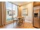 Bright dining area with large window offering outdoor views and stainless steel refrigerator at 7535 Brooklyn Dr, Kissimmee, FL 34747