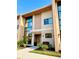 Modern two-story townhouse showcasing a stylish facade, a landscaped front yard, and large windows at 7535 Brooklyn Dr, Kissimmee, FL 34747