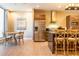 Well-appointed kitchen boasting stainless steel appliances, a center island, and an inviting dining space at 7535 Brooklyn Dr, Kissimmee, FL 34747