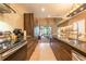 Modern kitchen showcasing sleek cabinetry, stainless appliances, and an open view to the living room at 7535 Brooklyn Dr, Kissimmee, FL 34747