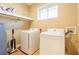 Laundry room showcasing a washer, dryer, and overhead storage shelf for added convenience at 7535 Brooklyn Dr, Kissimmee, FL 34747