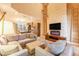 Spacious living room featuring plush seating, a unique fireplace, and contemporary design elements at 7535 Brooklyn Dr, Kissimmee, FL 34747