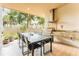 Covered outdoor kitchen features a built-in grill, dining table, and counter space for entertaining at 7535 Brooklyn Dr, Kissimmee, FL 34747