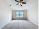 Spacious bedroom with ceiling fan and large window at 1001 Dampierre Ct, Kissimmee, FL 34759