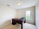 Bedroom with L-shaped desk and window view at 1001 Dampierre Ct, Kissimmee, FL 34759