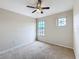 Spacious bedroom with ceiling fan and window at 1001 Dampierre Ct, Kissimmee, FL 34759