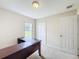 Home office with L-shaped desk and view of backyard at 1001 Dampierre Ct, Kissimmee, FL 34759