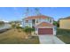 Two-story house, light blue exterior, brown roof and garage door at 1001 Dampierre Ct, Kissimmee, FL 34759