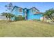 Front view of two-story light blue house with landscaping at 1001 Dampierre Ct, Kissimmee, FL 34759