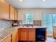 Kitchen with granite countertops, wood cabinets, and a double sink at 1001 Dampierre Ct, Kissimmee, FL 34759