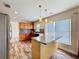 Kitchen island with granite countertop and pendant lighting at 1001 Dampierre Ct, Kissimmee, FL 34759