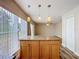 Kitchen island with granite countertop and pendant lighting at 1001 Dampierre Ct, Kissimmee, FL 34759