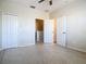 Well-lit bedroom with double doors leading to a hallway at 10710 Savannah Wood Dr # 107, Orlando, FL 32832