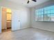 Bright bedroom featuring a private bathroom and window at 10710 Savannah Wood Dr # 107, Orlando, FL 32832