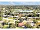 Aerial view of a residential area featuring houses and a central lake at 112 Azalea Ln, Sanford, FL 32773