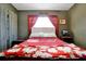 Bright bedroom featuring a red floral blanket and window at 112 Azalea Ln, Sanford, FL 32773