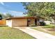 Ranch-style home with stone facade and driveway at 112 Azalea Ln, Sanford, FL 32773