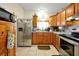 Cozy kitchen featuring wood cabinets, stainless steel appliances, and tile flooring at 112 Azalea Ln, Sanford, FL 32773