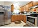 Bright kitchen with wood cabinets, stainless steel appliances, and tile floor at 112 Azalea Ln, Sanford, FL 32773