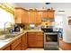 Updated kitchen with wood cabinets, stainless steel appliances, and tile flooring at 112 Azalea Ln, Sanford, FL 32773