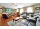 Living room with grey sectional sofa and wood flooring at 112 Azalea Ln, Sanford, FL 32773