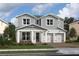 Two-story home with gray siding, white trim, and a two-car garage at 13106 Dendy Way # 19, Winter Garden, FL 34787