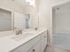 Bright bathroom with double sinks, a large mirror, and white cabinets for a clean and modern look at 13200 Faro Ct # 44, Winter Garden, FL 34787