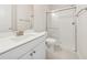 Bathroom featuring a modern shower, white vanity and toilet set against light-colored walls and tile flooring at 13200 Faro Ct # 44, Winter Garden, FL 34787