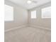 Bright bedroom featuring neutral walls, plush carpeting, and natural light from three large windows at 13200 Faro Ct # 44, Winter Garden, FL 34787