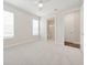 Bright bedroom features plush carpeting, and natural light from windows, leading to the bathroom and hallway at 13200 Faro Ct # 44, Winter Garden, FL 34787